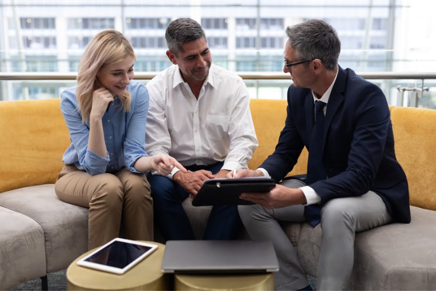 people carry out sales coaching feedback using a tablet