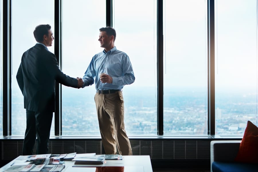 two sales coaches meeting and discussing